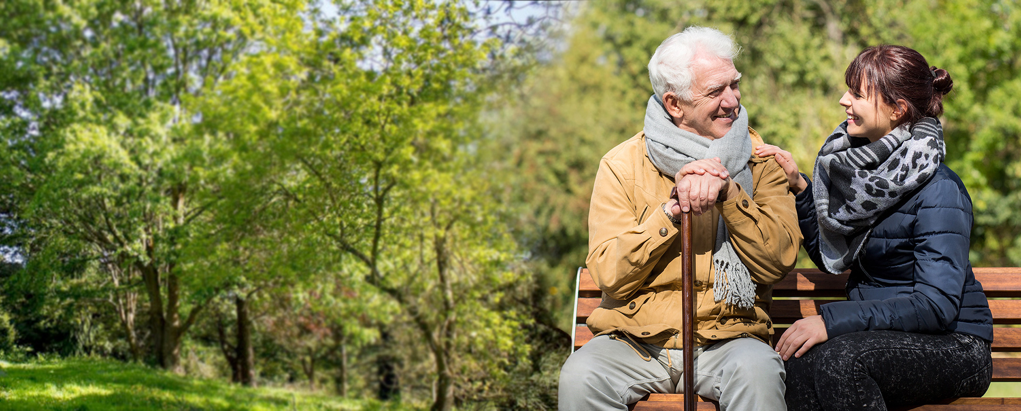 Man and woman sitting on a park bench