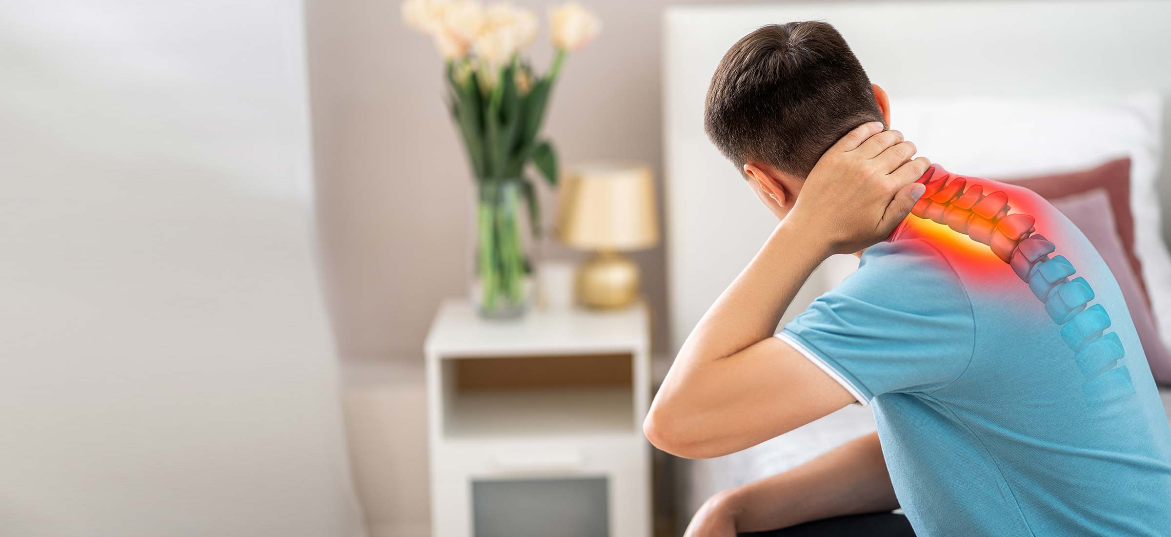 A young man in a blue shirt holds the back of his neck above a drawing of his spine and neck pain.