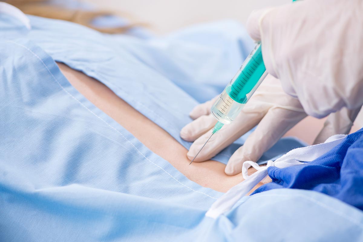 Female patient getting an injection at a clinic.