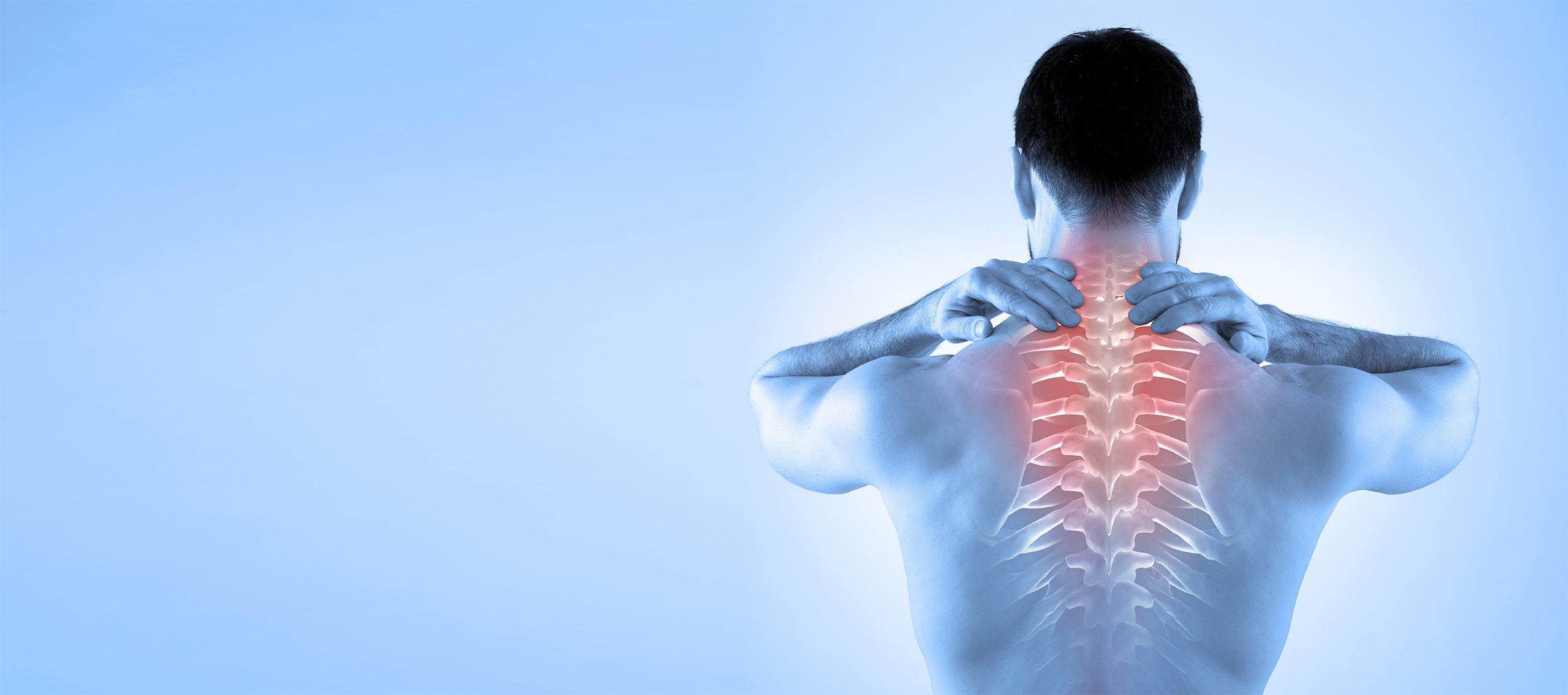 A man with head and neck pain rubs the back of his neck and spine against a blue background