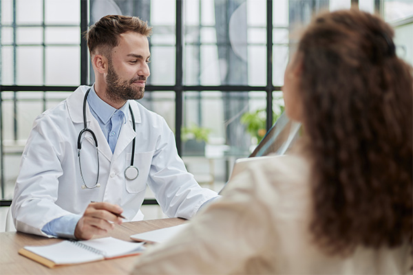 Concentrated male doctor looking at x-ray picture of spine.