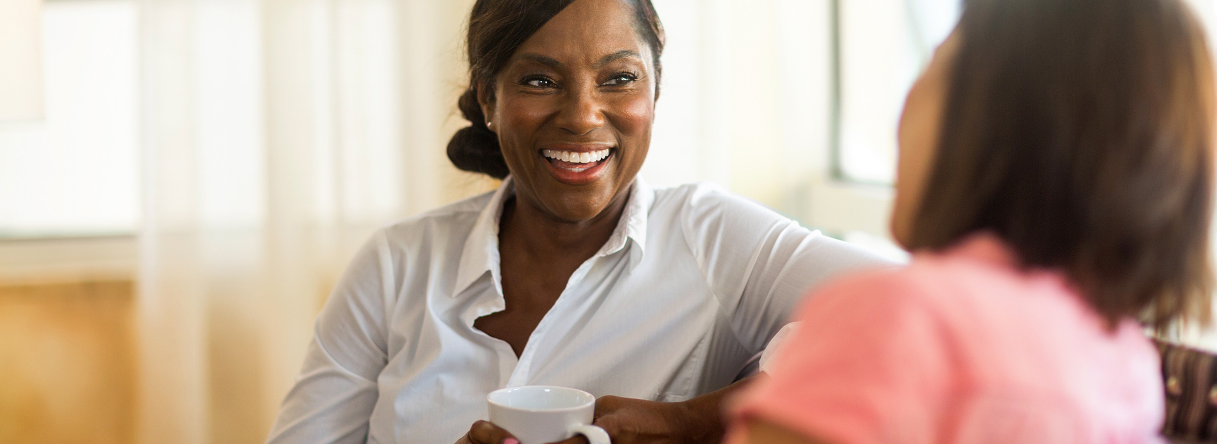 Two women having coffee share their personal experiences with incontinence