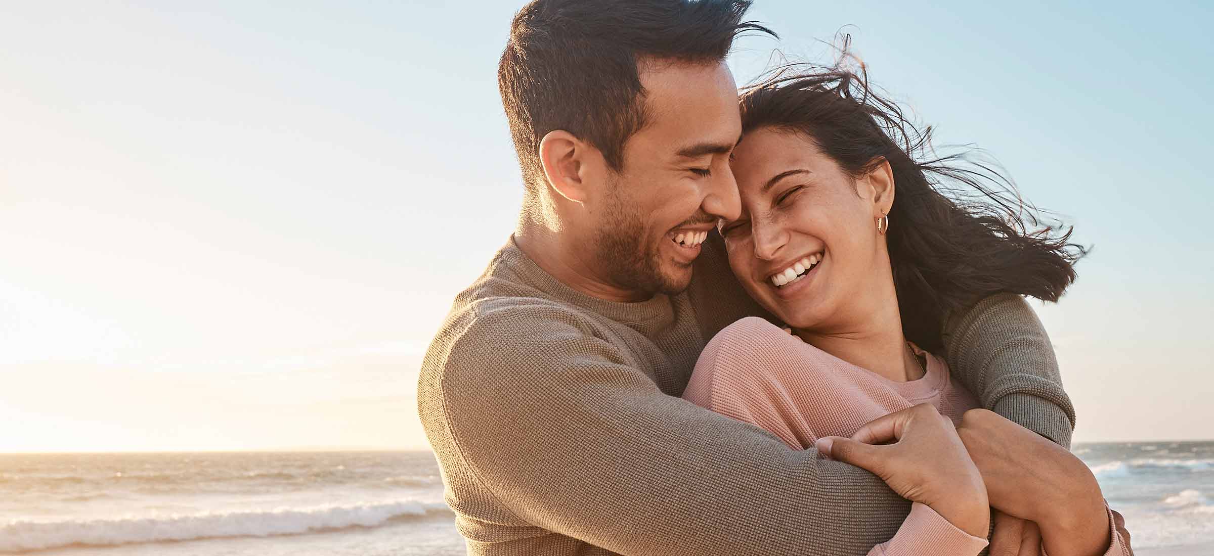 Young couple having fun at the beach together.