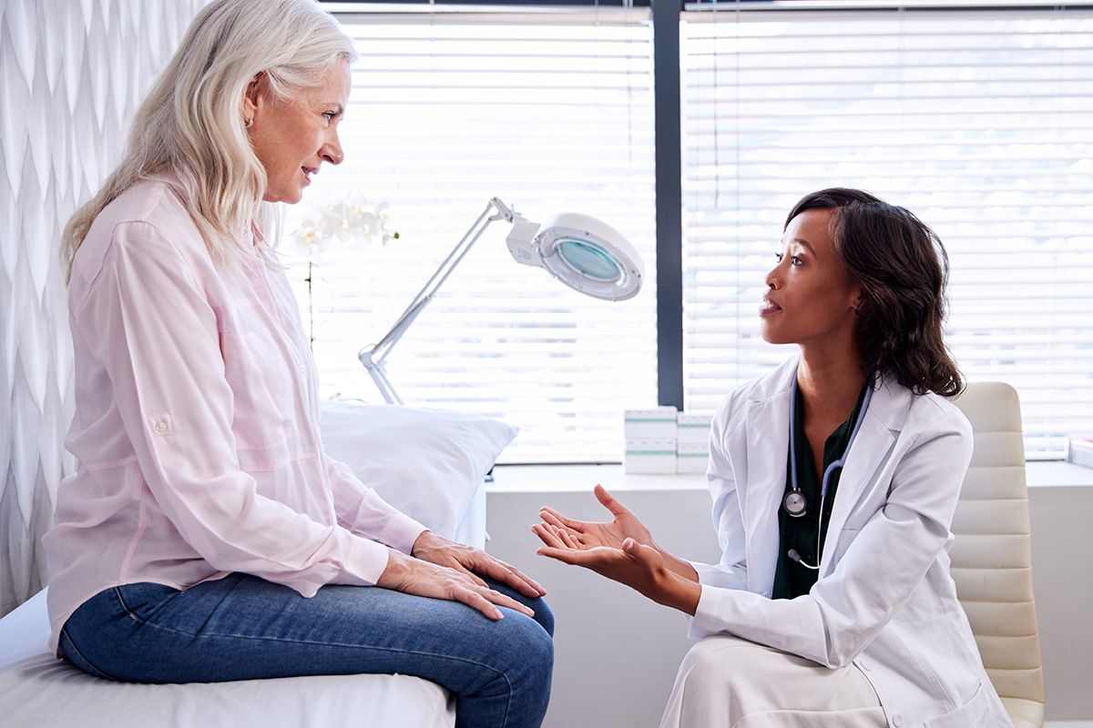 Doctor speaking to a female patient in a consultation room
