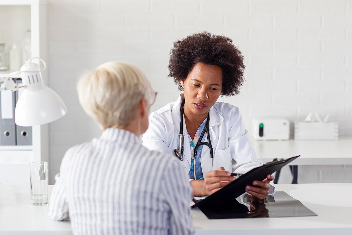 Doctor discusses information with a patient during a medical consultation