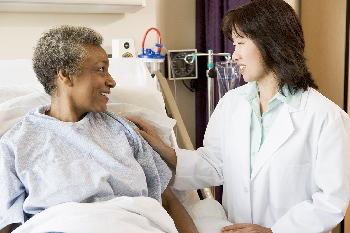 Doctor speaking to a female patient in a hospital room