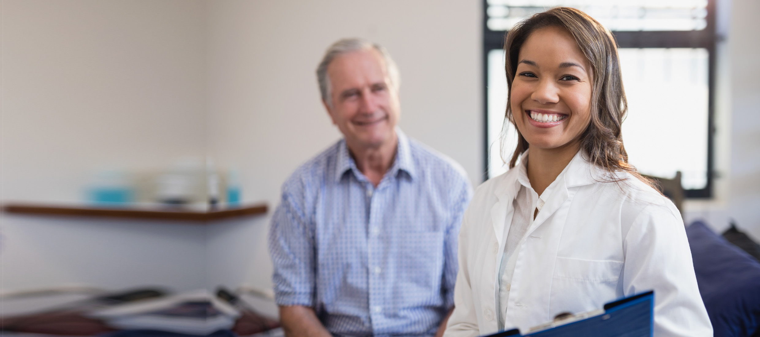 Doctor and older adult, male patient in a medical office