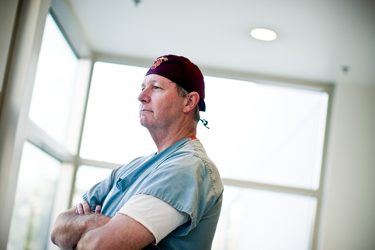 Male doctor standing by a window