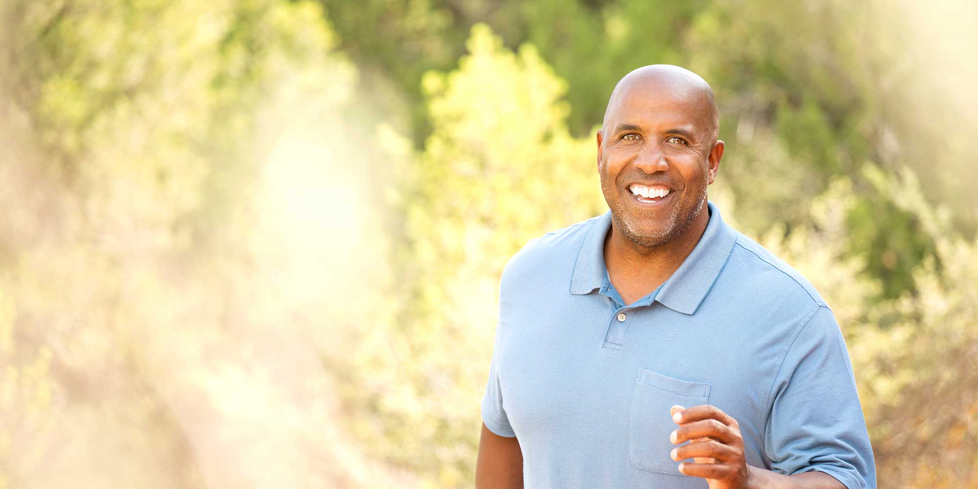 Middle-aged man jogging in park