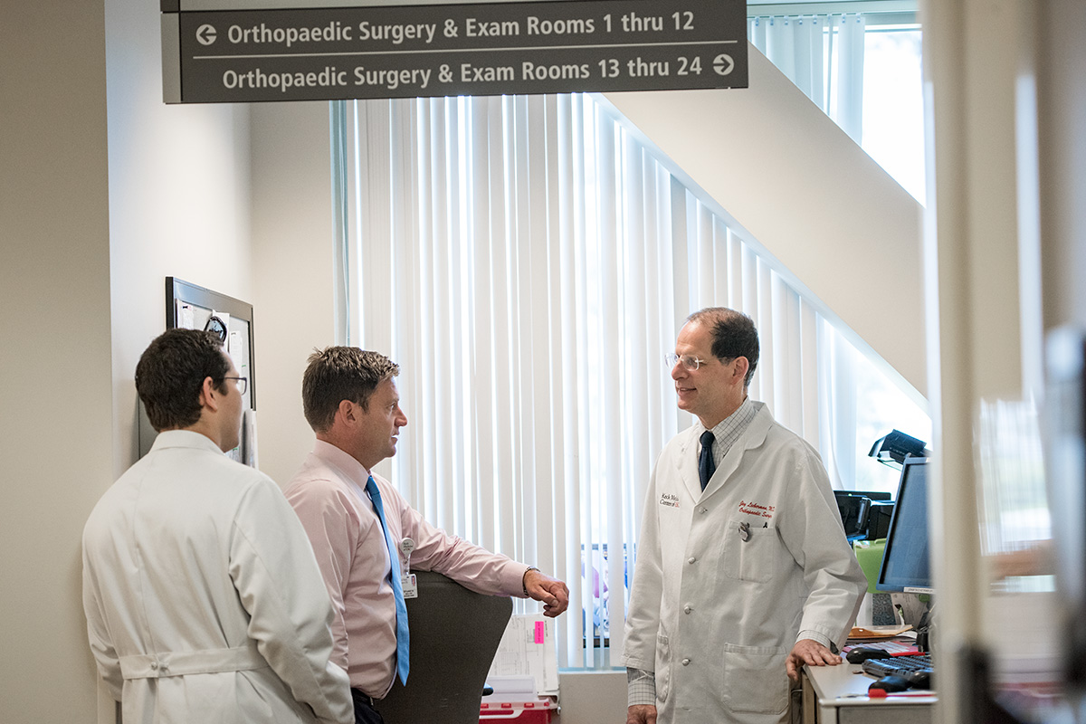 Male Keck Medicine orthopedic surgeons discuss shoulder pain and frozen shoulder in a medical setting