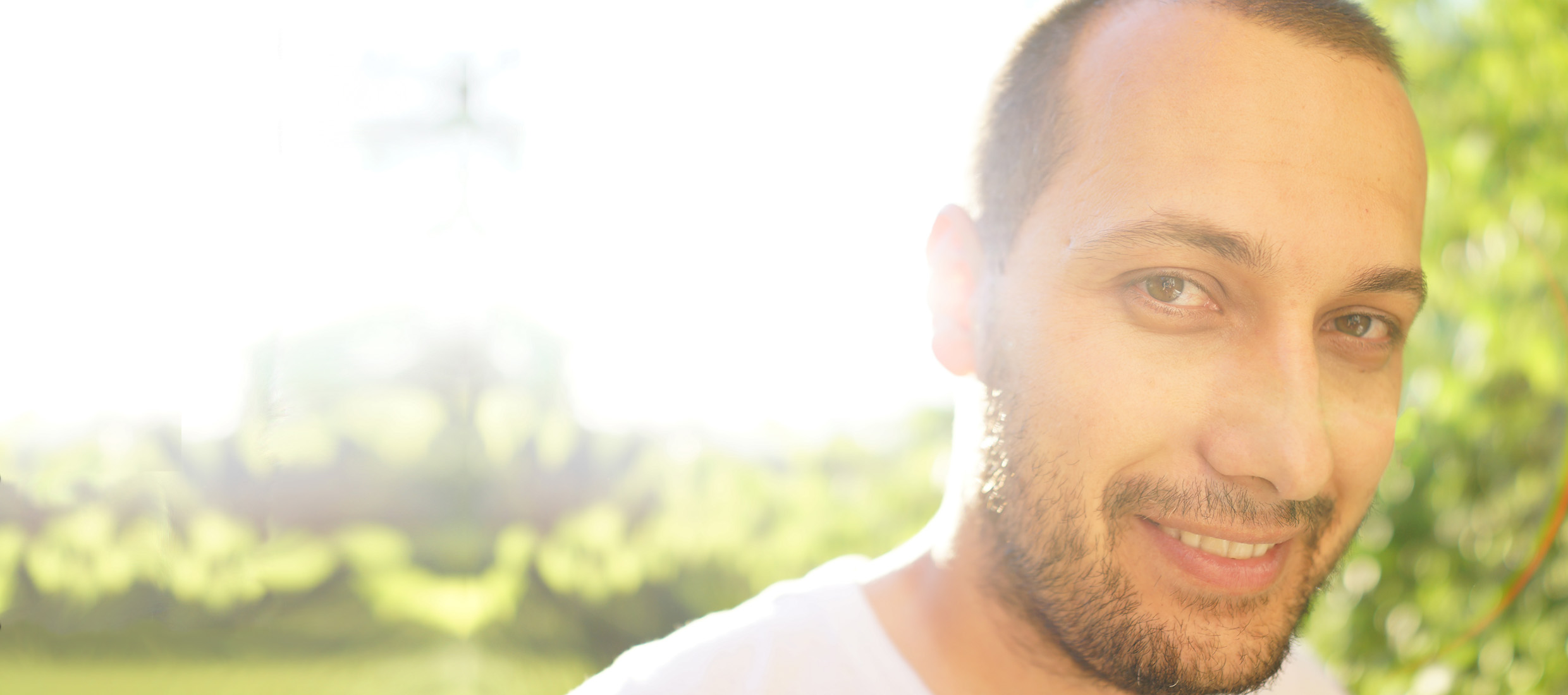 A man who has been treated for strabismus smiles as he walks in a park