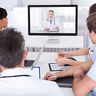 Medical professionals conducting a remote tele-consultation for a second opinion.