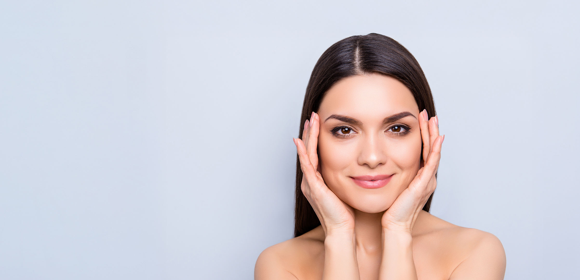 Pretty aesthetic woman with natural makeup enjoying her flawless perfect skin after a plastic reconstructive procedure.