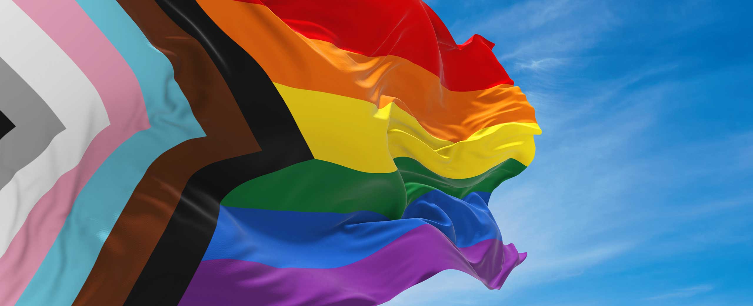 LGBTQ+ Gay Representation Progress Pride Flag in Front of Blue Sky