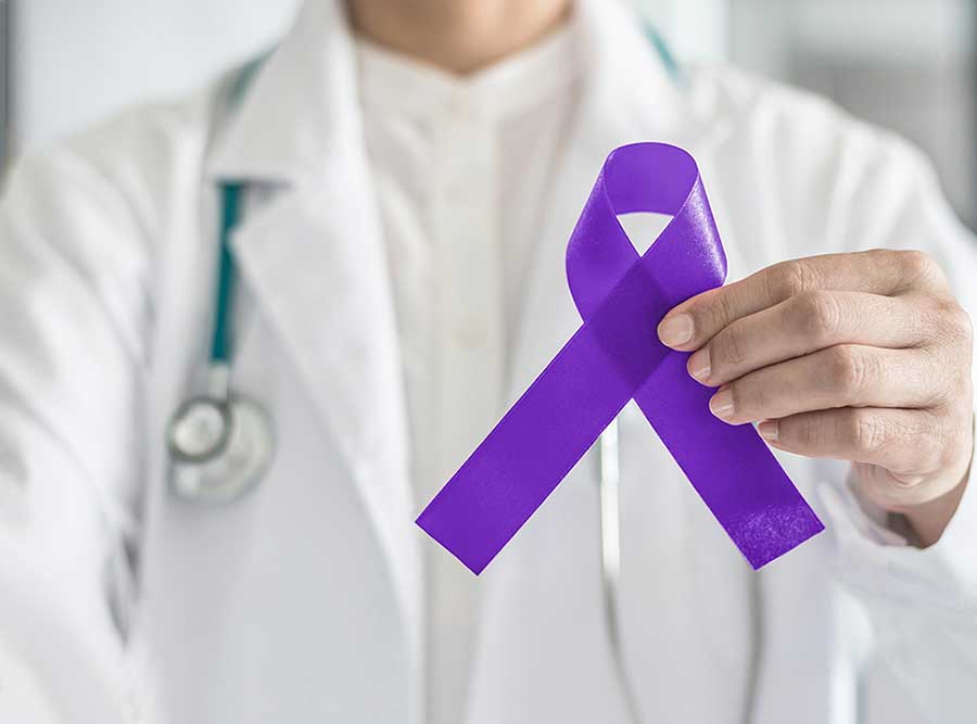 Doctor holding a purple pancreatic cancer awareness ribbon