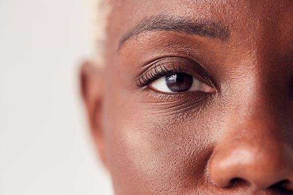 Close up of eyes on a woman with dyed hair.