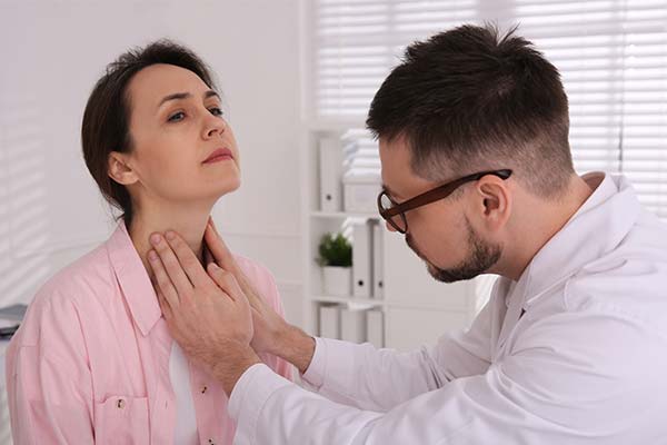 Person getting neck checked by a physician
