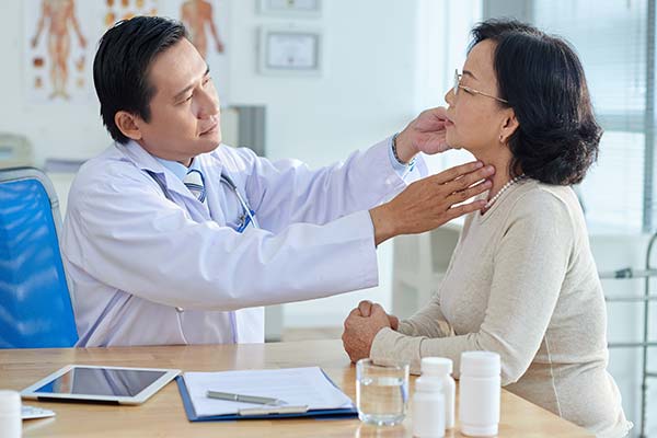 Physician checking a patient's neck