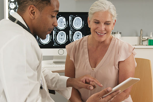 A doctor shows a patient her results.