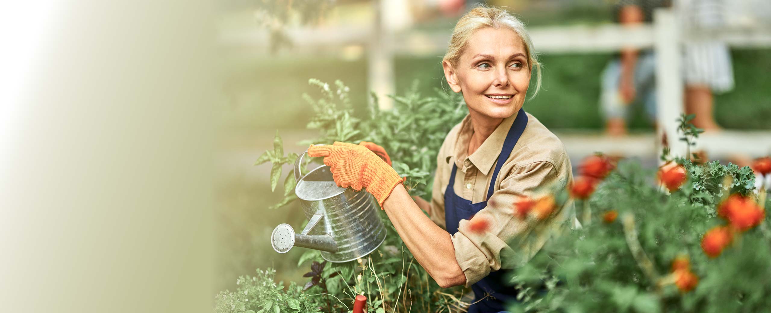Happy senior female gardening outdoors.