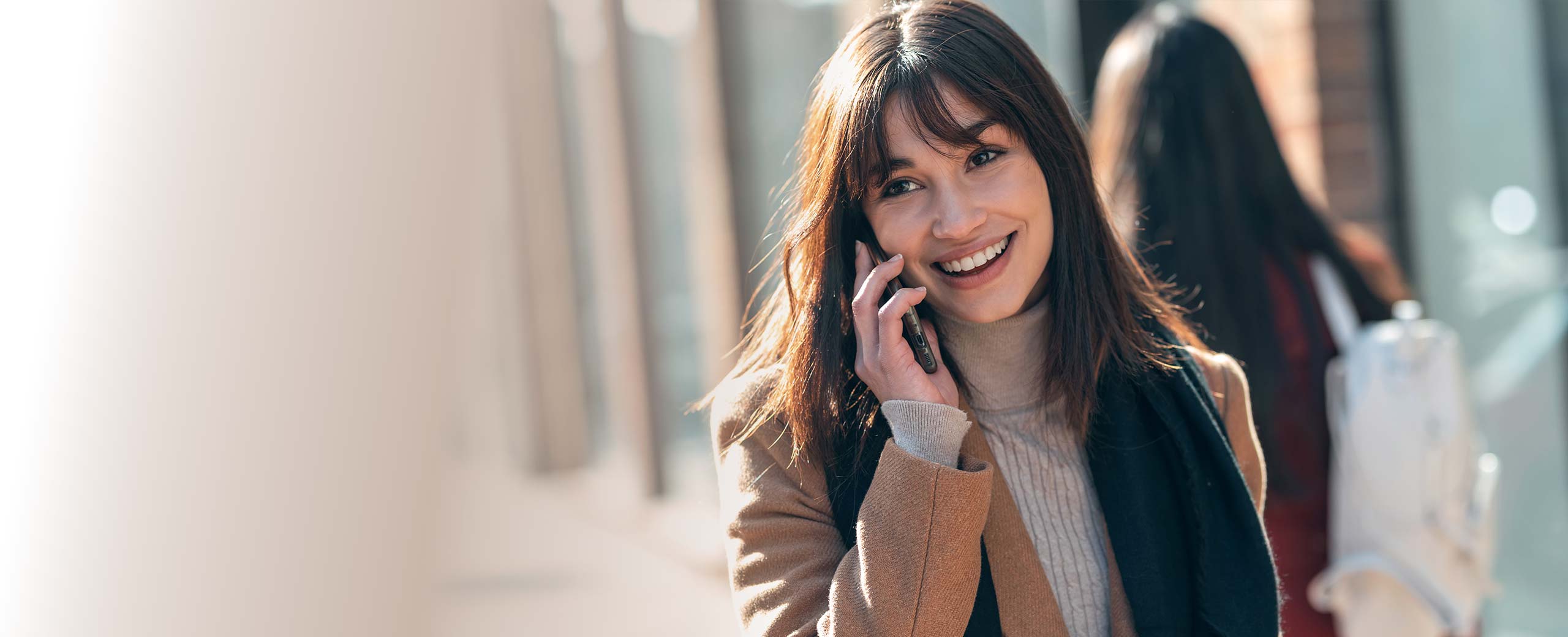 Young woman outdoors talking on cell phone.