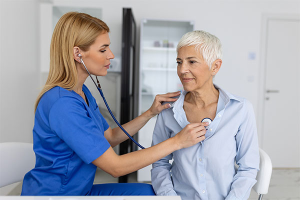 A woman gets checked by a doctor during a consultation for atrial fibrillation.