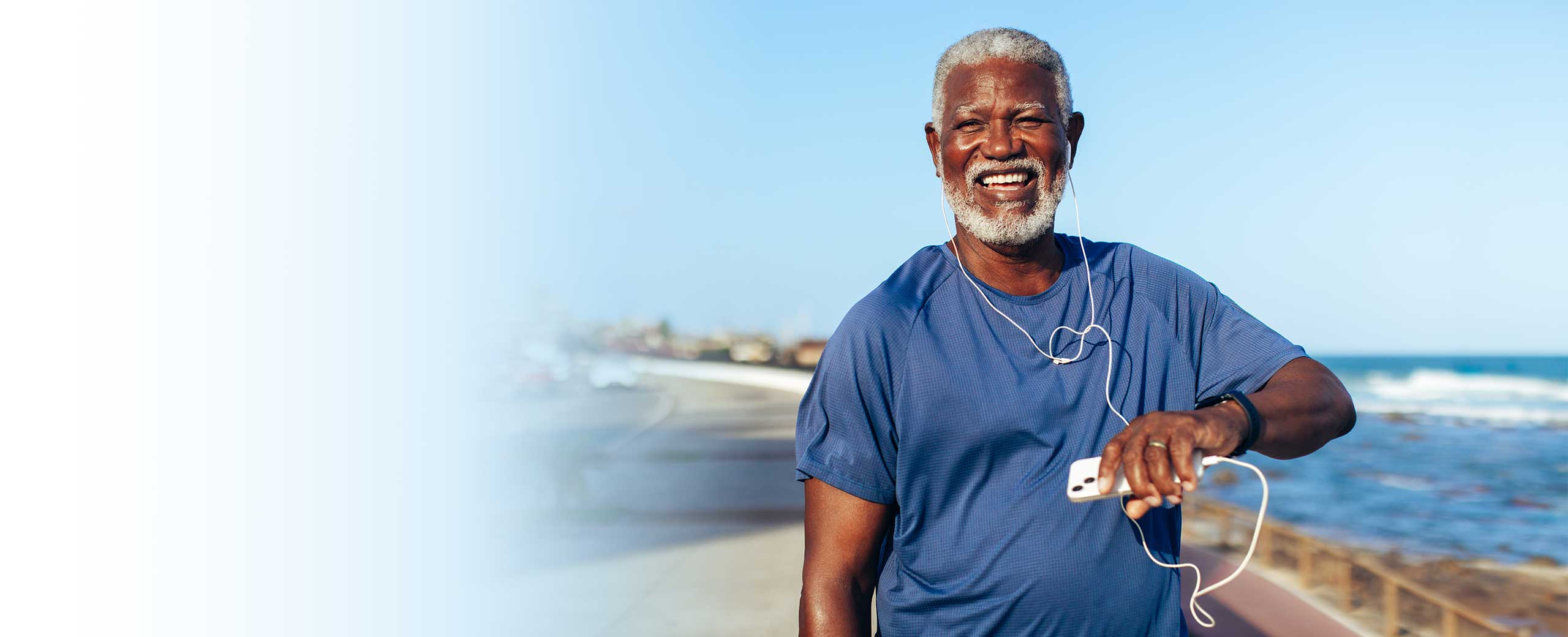 A man with cardiac amyloidosis smiles on a beach.