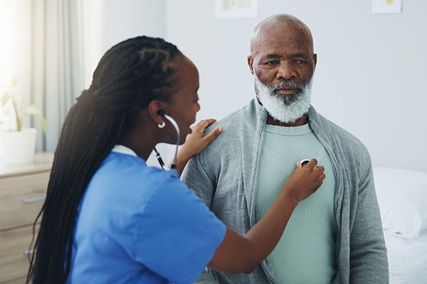 A doctor checks a man's heart for cardiac arrhythmias.