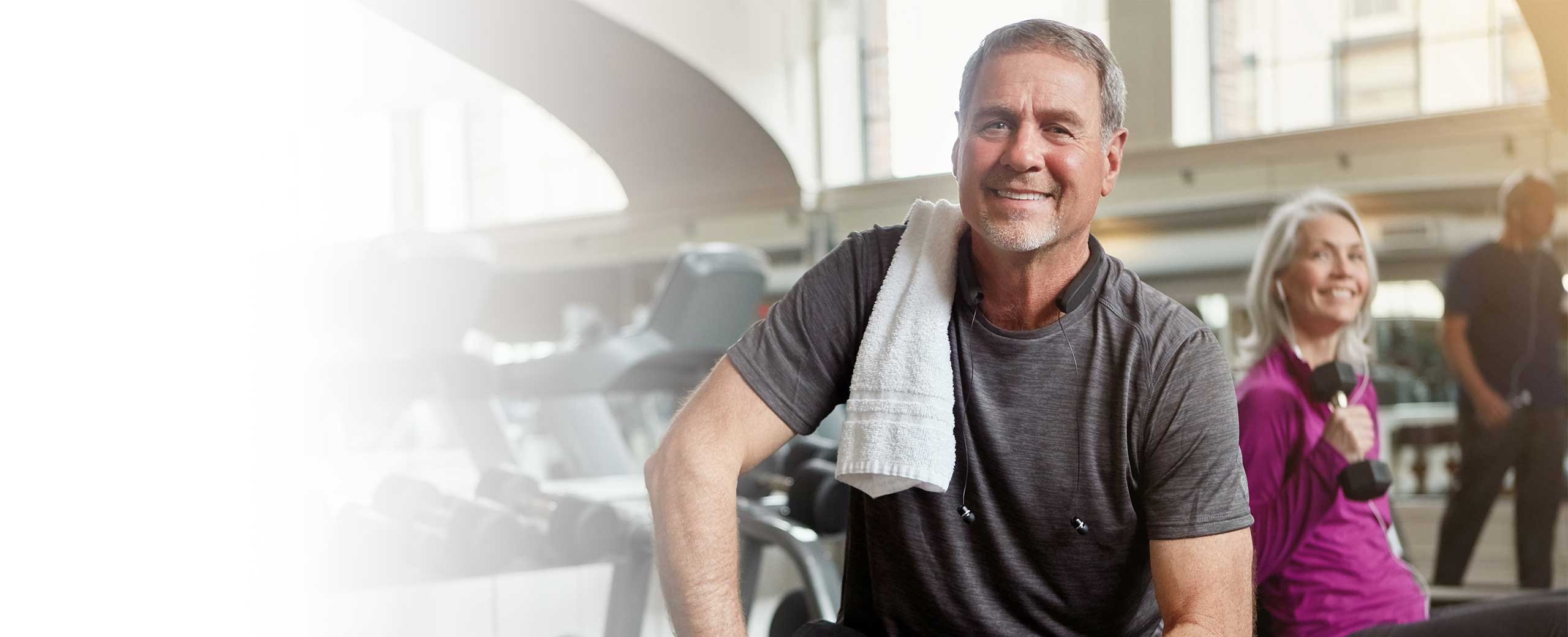 A man smiles at the gym.