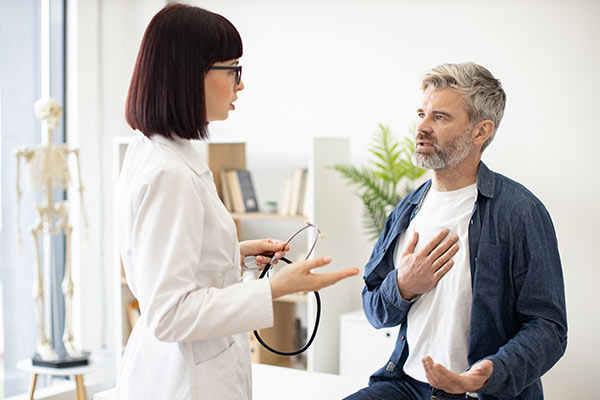 A man speaks with his cardiologist.