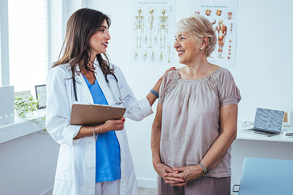 A doctor consults with a woman about a transcatheter valve replacement.