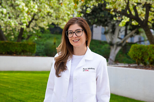 Dr. Lily Dara standing outside in a white medical coat.